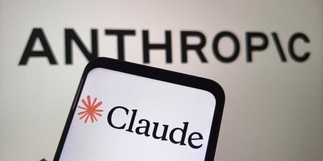 Claude shown on a phone in front of Anthropic signage. Credit: Claude Security.