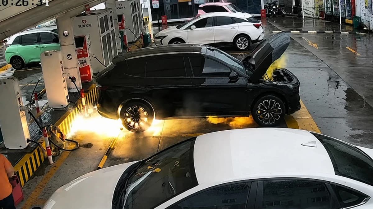 Electric SUV near a charging station as investigators examine a thermal incident.
