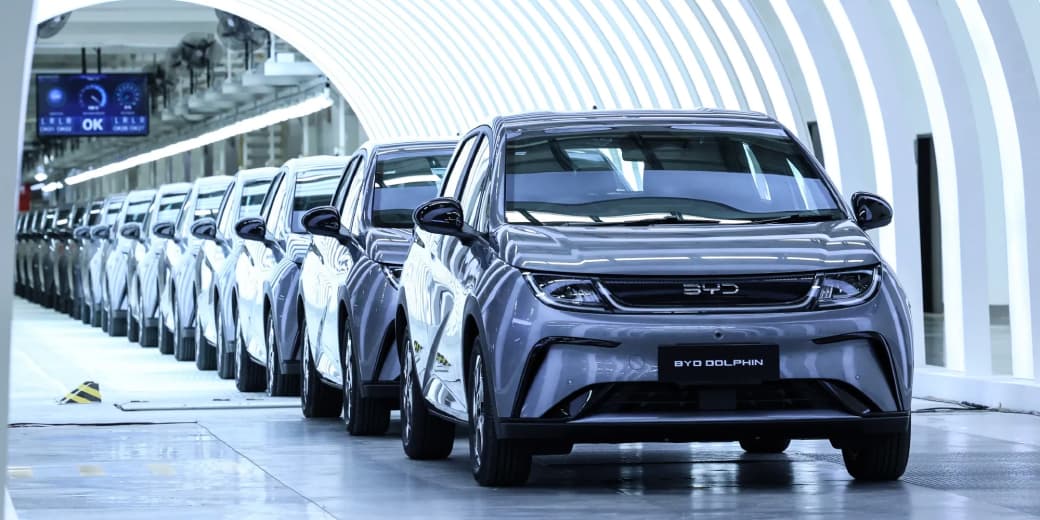 BYD Dolphin electric cars lined up inside a factory. Credit: Valeria Mongelli / Bloomberg.