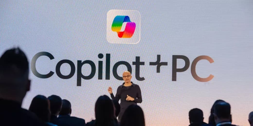 Microsoft Copilot Plus PC presentation on a stage.