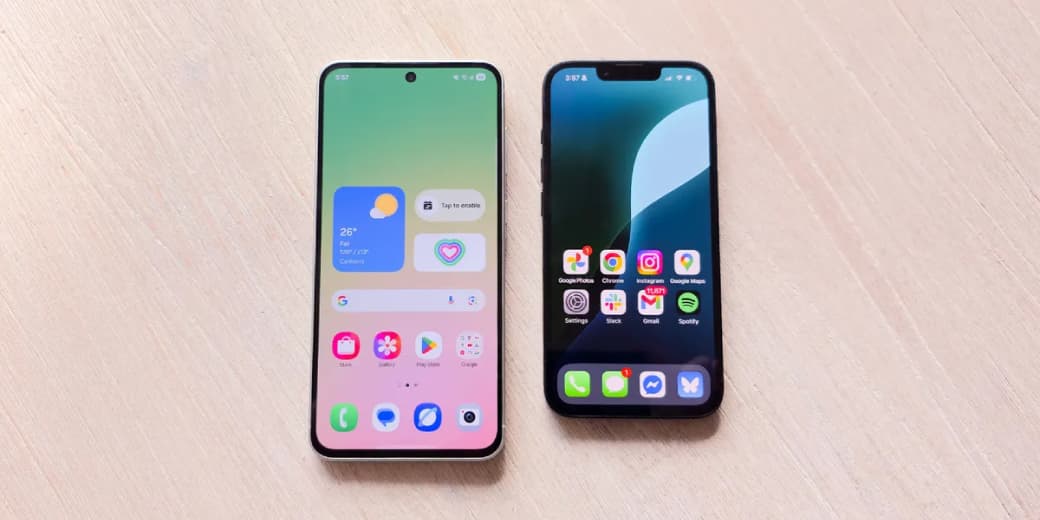 A midrange Android phone beside an iPhone on a table.