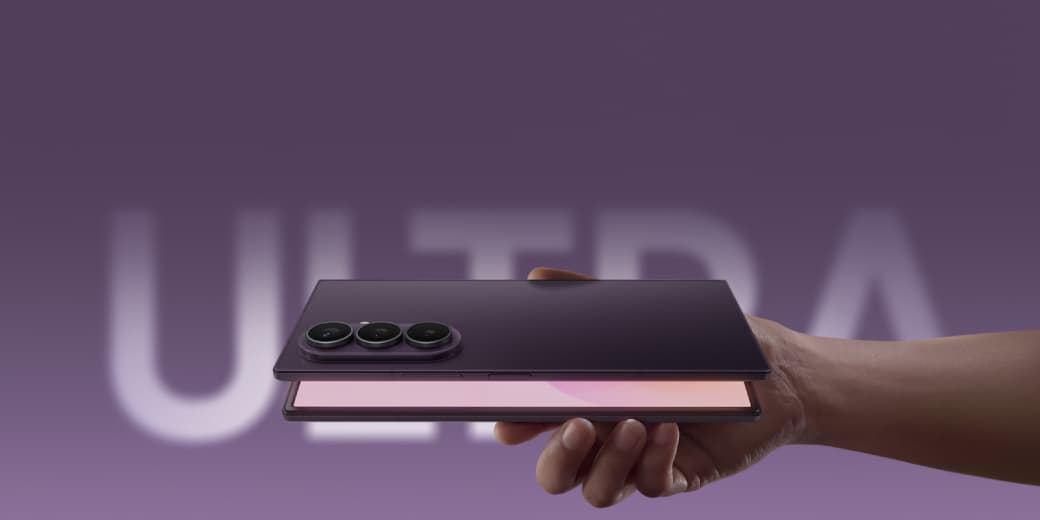 The Samsung Galaxy Z Fold8 Ultra held folded in one hand, showing its triple rear cameras against a purple Ultra backdrop. Credit: Samsung.