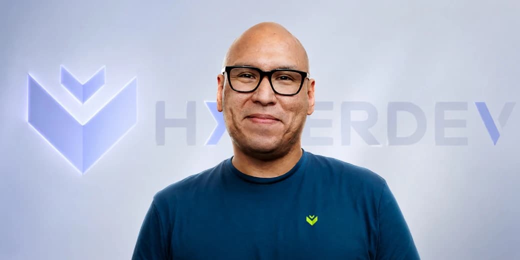 A HyperDev executive standing in front of the South African AI startup's logo.