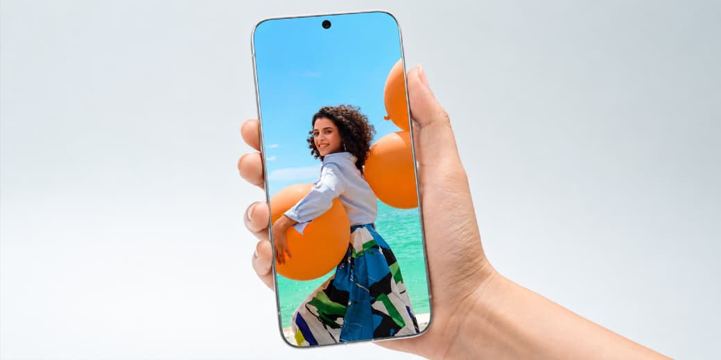 TECNO 0mm-bezel concept phone held upright in one hand with its display reaching the frame.